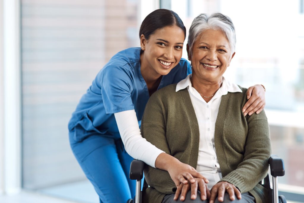portrait, medical or disability with a nurse and old woman in a wheelchair during a nursing home visit. smile, healthcare or retirement with a happy female medicine professional and senior client